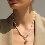 Golden Heart Necklace features a vibrant green heart pendant. 18K gold-plated, waterproof, and hypoallergenic