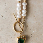 Golden Heart Necklace features a vibrant green heart pendant. 18K gold-plated, waterproof, and hypoallergenic