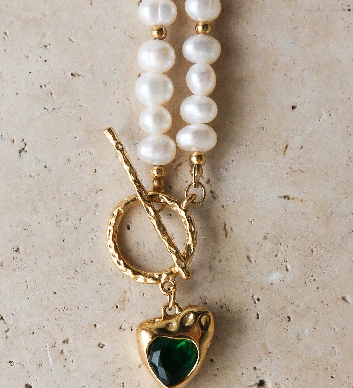 Golden Heart Necklace features a vibrant green heart pendant. 18K gold-plated, waterproof, and hypoallergenic