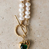 Golden Heart Necklace features a vibrant green heart pendant. 18K gold-plated, waterproof, and hypoallergenic