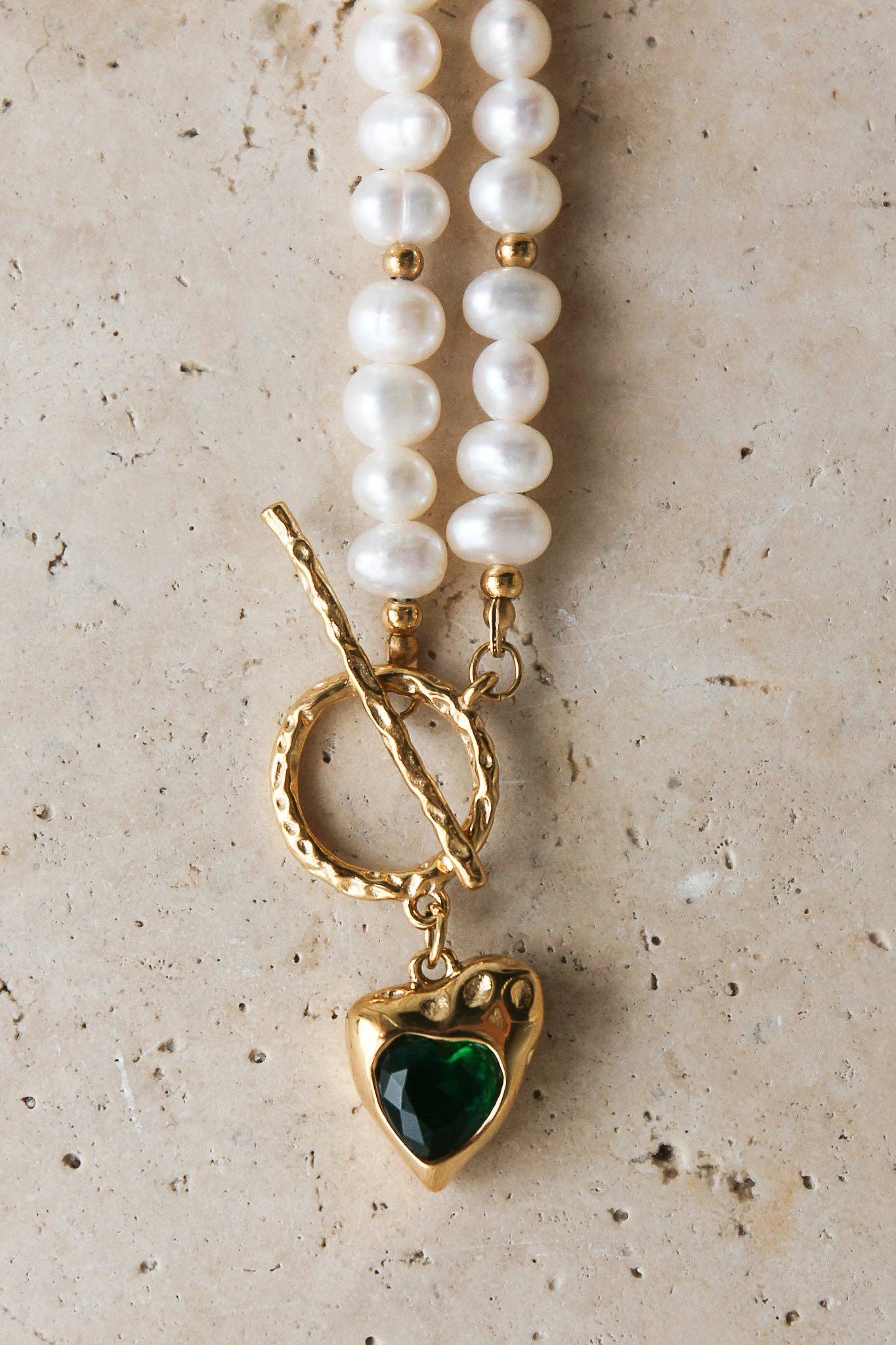 Golden Heart Necklace features a vibrant green heart pendant. 18K gold-plated, waterproof, and hypoallergenic