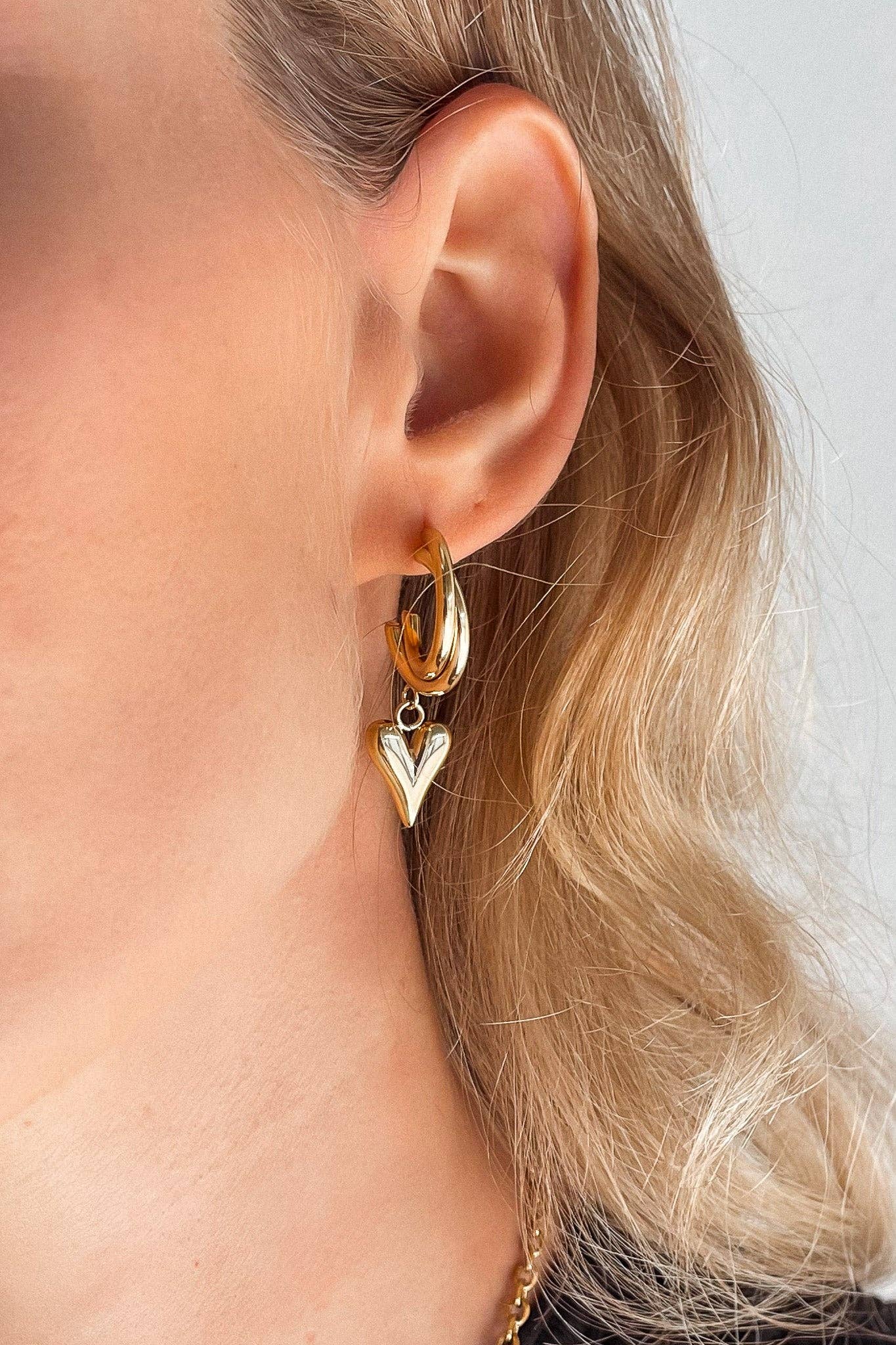 Heart Gold Earrings. 18K gold-plated, hypoallergenic & tarnish-resistant on model