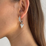 Heart Silver Earrings. Hypoallergenic, tarnish-resistant & waterproof, featuring a delicate heart charm on model
