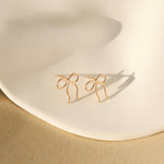 Petite Bow Stud Earrings add a chic, feminine touch. 14K gold fill or sterling silver, hypoallergenic & water-safe.
