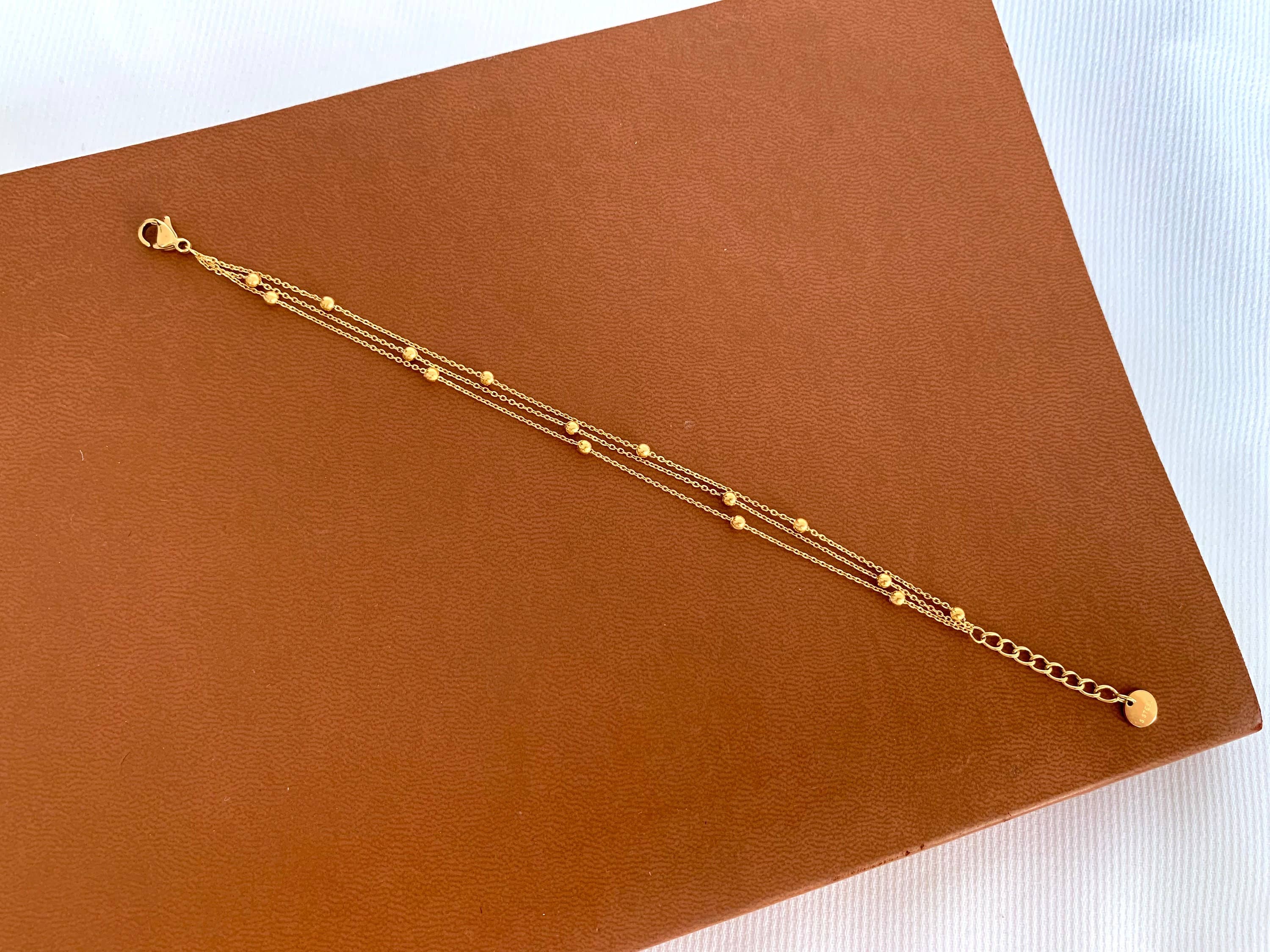 Trinity Layered Bracelet features three fine gold-plated chains. Hypoallergenic, tarnish-resistant & water-safe