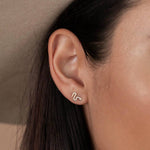 Year of the Snake, these gold-plated stud earrings feature CZ stones