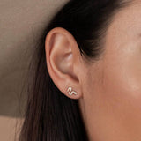 Year of the Snake, these gold-plated stud earrings feature CZ stones