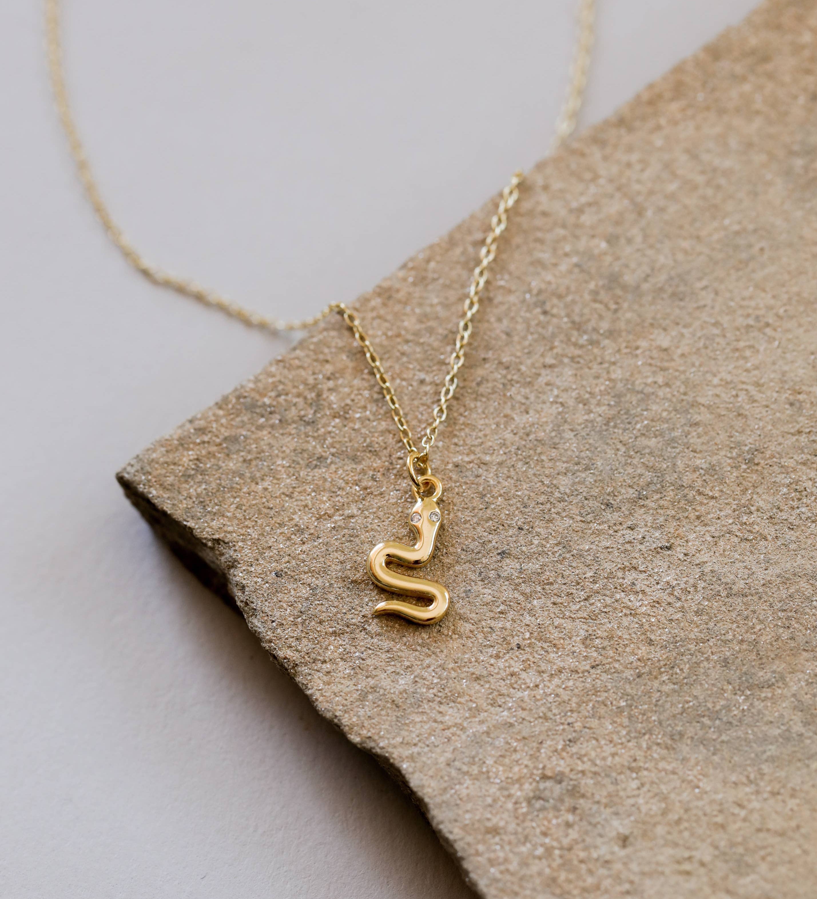 Year of the Snake, this gold-plated necklace features CZ stones